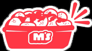 Red container of popcorn with M branding label and popcorn pieces overflowing