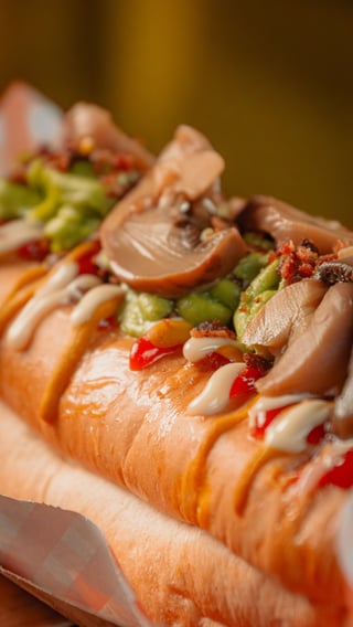 Gourmet hot dogs topped with sautéed peppers and onions